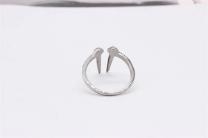 Macro shot of silver nail design ring made of durable titanium steel with a polished finish