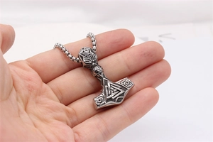 Detail of Viking Thor hammer necklace featuring Valknut symbol and antique steel finish