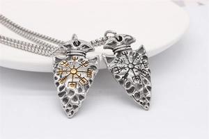 Detail of Viking Vegvisir compass arrow pendants in silver and gold finishes with box chain