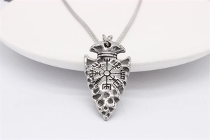 Macro view of vintage silver Viking Vegvisir compass engraving on the arrow pendant necklace