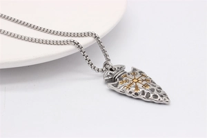 Detailed close-up of a vintage Viking arrow pendant with golden Vegvisir symbol detail