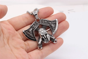 Detailed close-up of a Viking axe and Spartan helmet pendant in vintage stainless steel