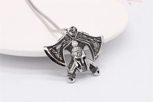 Macro detail of Nordic Viking battle axe pendant with Spartan helmet in retro steel