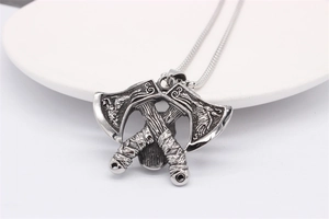 Detailed close-up of vintage silver viking double axe pendant with engraved patterns