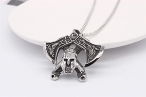 Macro detail of vintage Viking axe and Spartan helmet pendant in retro steel finish