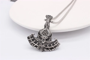 Macro shot of Viking axe pendant with Valknut symbol and vintage steel finish on round chain