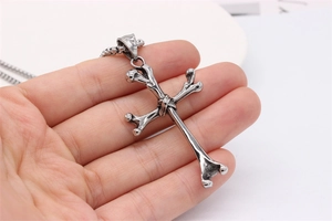 Detailed view of a retro gothic bone cross pendant necklace in distressed titanium steel
