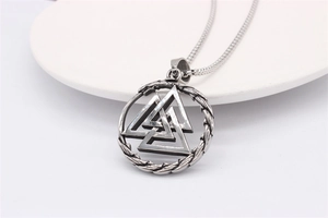 Macro detail of Nordic Viking Valknut pendant with retro stainless steel braided texture