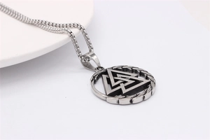 Macro detail of silver Valknut pendant with woven ring and stainless steel box chain