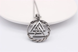 Detail of vintage silver titanium steel Viking Valknut pendant with woven rope edge
