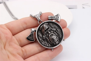 Macro view of a Viking warrior relief pendant with axes on a vintage silver ball chain