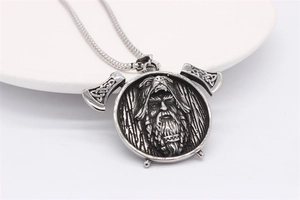 Macro detail of Nordic Viking ax pendant with intricate shield relief on stainless steel