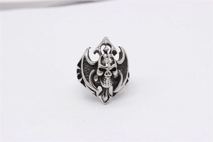 Close-up of gothic skull ring featuring detailed wings and cross in vintage silver