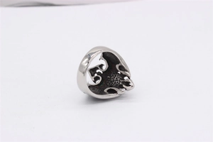 Macro shot of silver gothic eagle ring featuring intricate 3D relief and honeycomb texture