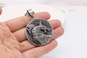Macro detail of Nordic Viking Fenrir wolf head relief on vintage steel pendant