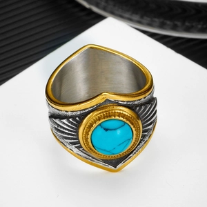 Macro shot of retro steel ring with turquoise stone and eagle feather carving