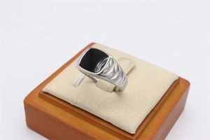 Detail eines Titanrings in Silber mit schwarzer Quadrateinlage und gerillter Textur