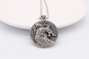 Close-up of vintage Nordic Viking wolf totem pendant with Celtic knot details