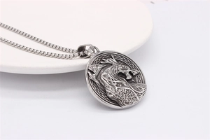Detailed view of vintage Viking wolf pendant with Celtic knot on a bead chain