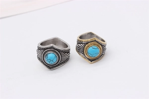 Close-up of retro titanium steel feather rings with blue turquoise stone inlays
