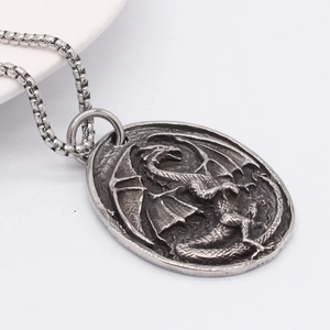 Retro stainless steel dragon relief oval pendant necklace with a vintage silver finish