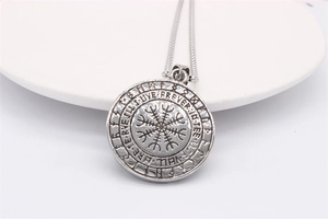 Macro detail of silver Viking Vegvisir compass pendant with Forever In Thee engraving