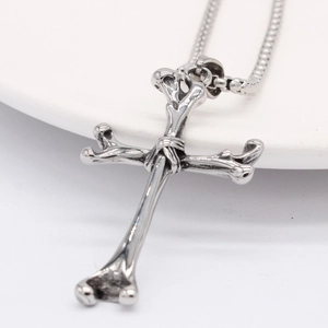 Gothic cross necklace for men featuring realistic bone design and steel box chain