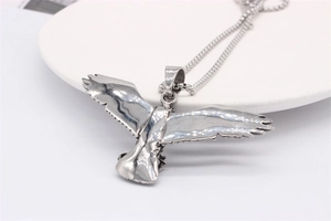 Detailed view of vintage silver eagle pendant necklace with intricate wing texture