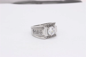 Macro view of men's titanium wedding ring with large round zircon and pavé diamond details