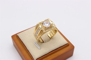 Detailed macro view of men's gold titanium ring with square face and large round diamond