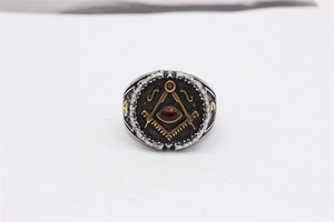Macro detail of vintage Freemason ring with red gemstone and gold masonic symbols