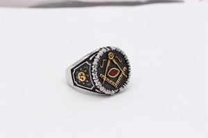 Macro detail of retro Masonic ring with red gemstone and compass emblem in steel