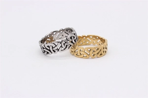 Close-up of Celtic knot patterns on vintage silver and gold stainless steel rings
