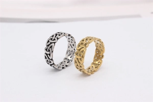 Close-up of gold and silver stainless steel rings with Celtic knot hollow pattern