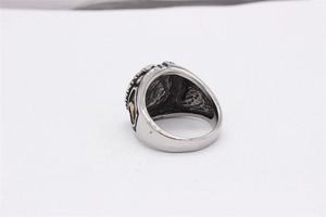 Macro detail of vintage Masonic titanium steel ring with gold accents and retro finish