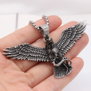 Retro eagle and snake titanium steel pendant necklace shown in hand for size