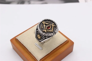 Detail of vintage Masonic ring with gold compass symbol and red marquise stone