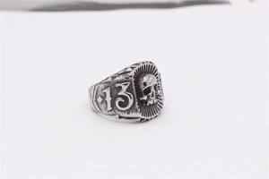 Macro view of vintage stainless steel ring featuring engraved number 13 on the side
