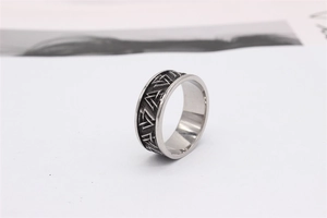 Macro view of vintage silver steel ring with Nordic Valknut symbols and textured finish
