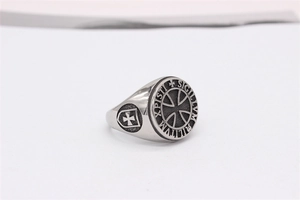 Macro view of vintage Templar signet ring with engraved cross and Latin inscription