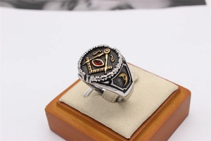 Retro Masonic ring close-up showing red marquise gemstone and compass symbol detail