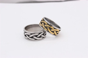 Macro detail of retro Celtic braided Viking rings in silver and two-tone steel finish