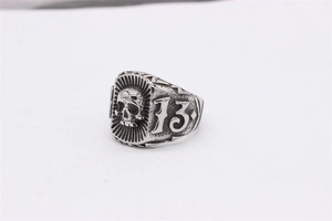 Macro shot of retro stainless steel ring featuring 3D skull embossment and number 13