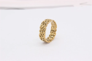 Detailed view of golden Celtic knot pattern on hollowed-out vintage titanium steel ring