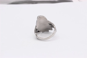 Macro view of vintage owl ring in antique silver steel with detailed textured engraving