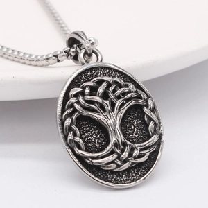 Vintage Celtic Tree of Life oval pendant necklace in stainless steel on white background