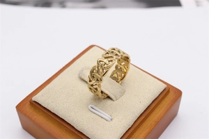 Detailed view of golden stainless steel ring with vintage hollow Celtic knot patterns