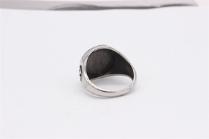 Detail view of the silver vintage titanium steel cross signet ring for men in matte finish