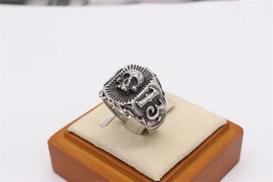 Macro shot of retro gothic 13 skull stainless steel ring on a wooden display stand
