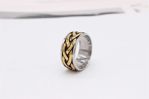 Detail of Viking style titanium steel ring with gold braided knot and silver edges